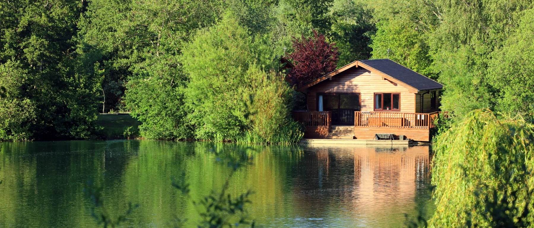 Image of a wooden lodge lakeside